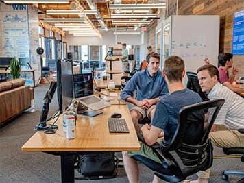 Developers collaborating in modern office space